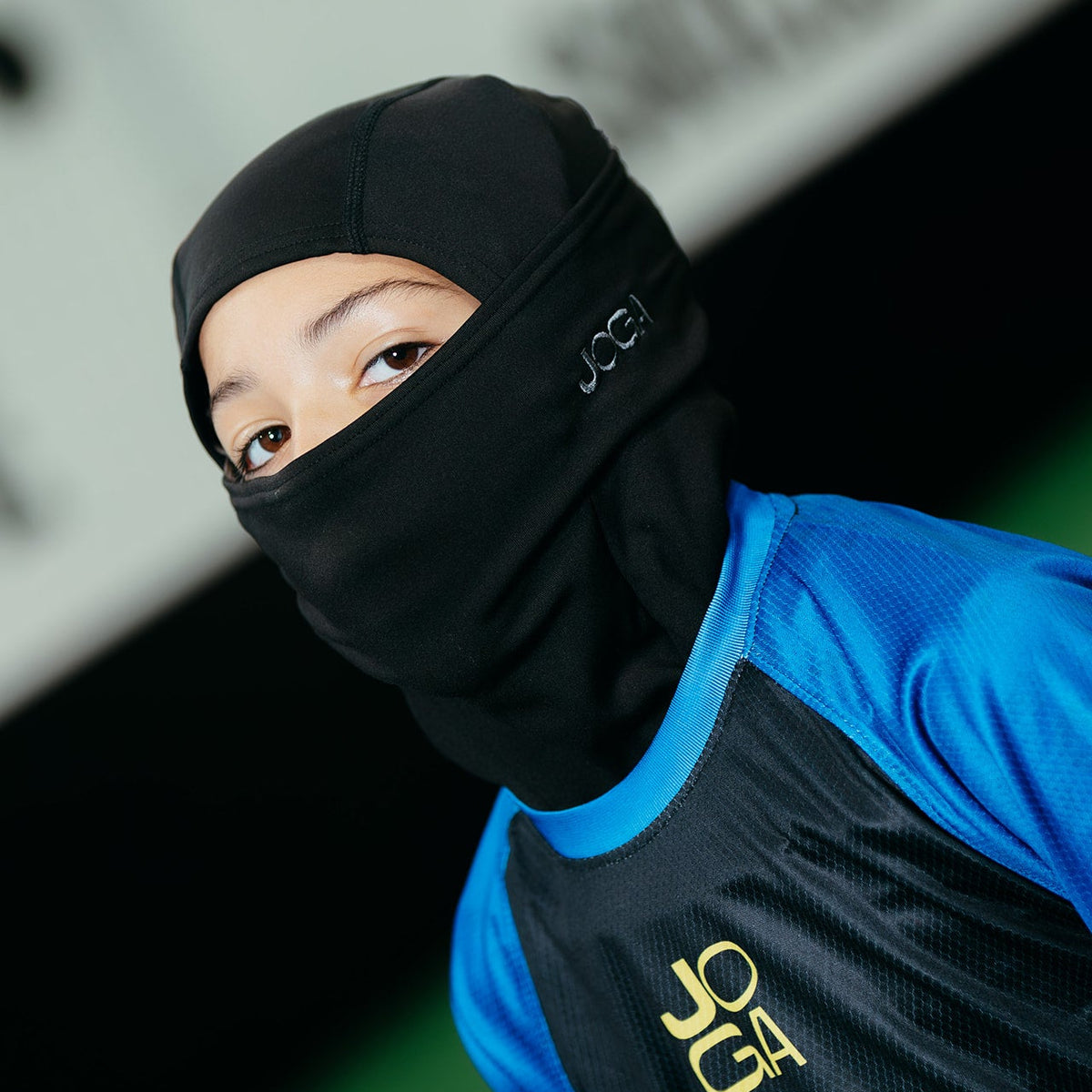 Young athlete wearing JOGA Starz balaclava during outdoor soccer training